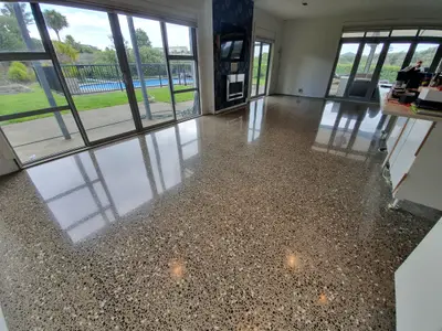 Diamond Shine Concrete high-gloss polished concrete kitchen floor with timber island in luxury Auckland home