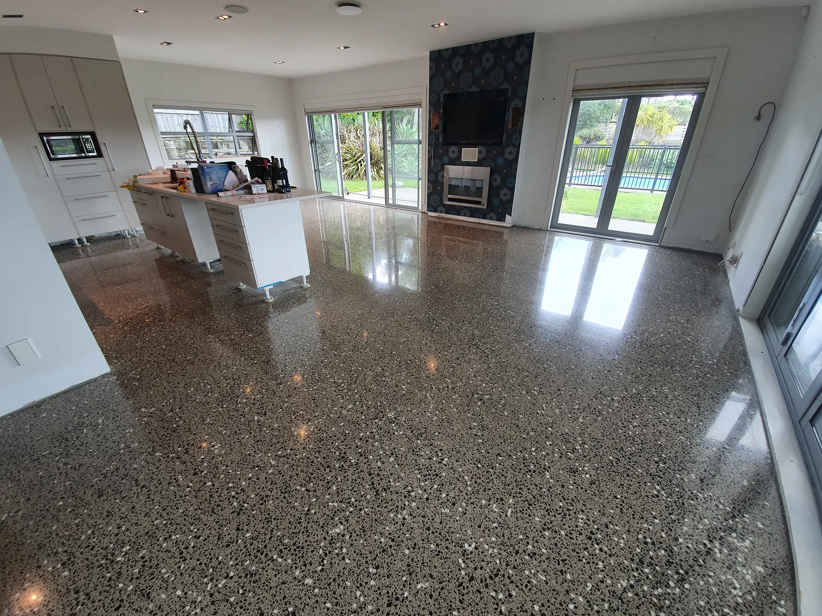 Diamond Shine Concrete polished concrete open-plan living floor with garden views in Auckland home refurbishment