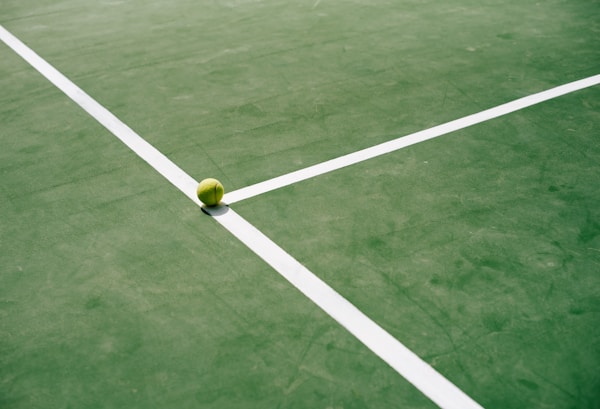 a tennis ball sitting on a tennis court