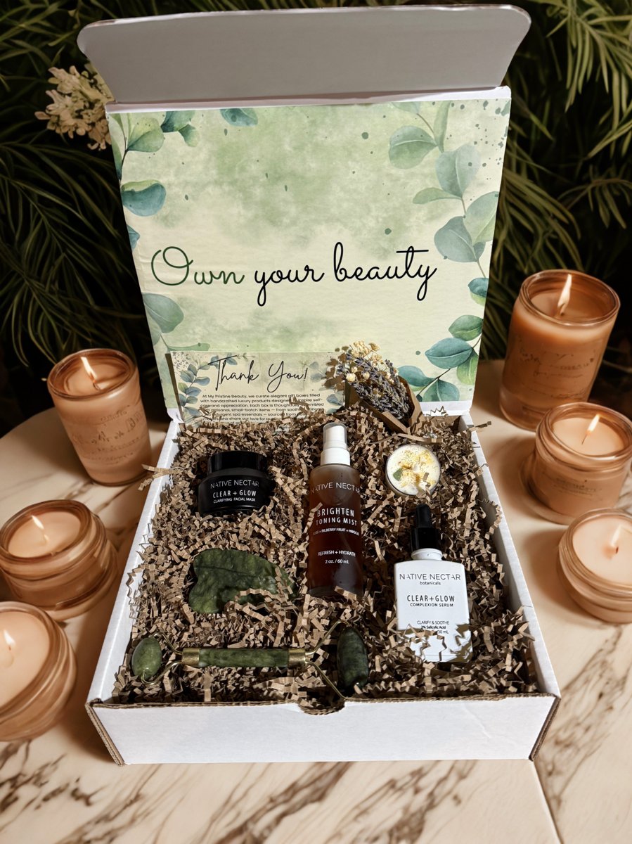 Katari Black Seed Mediterranean black seed oil in a glass bottle next to its white packaging box and decorative green leaves.