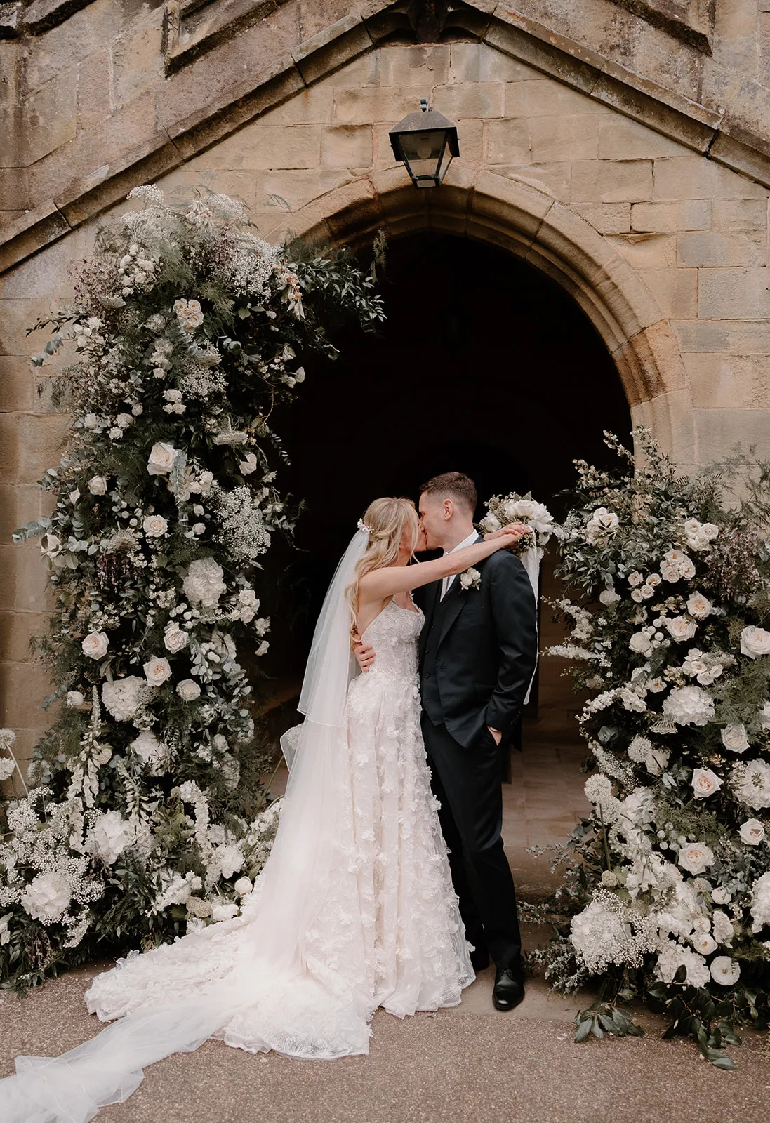 Breathtaking floral arch at a church by cheshire wedding florist