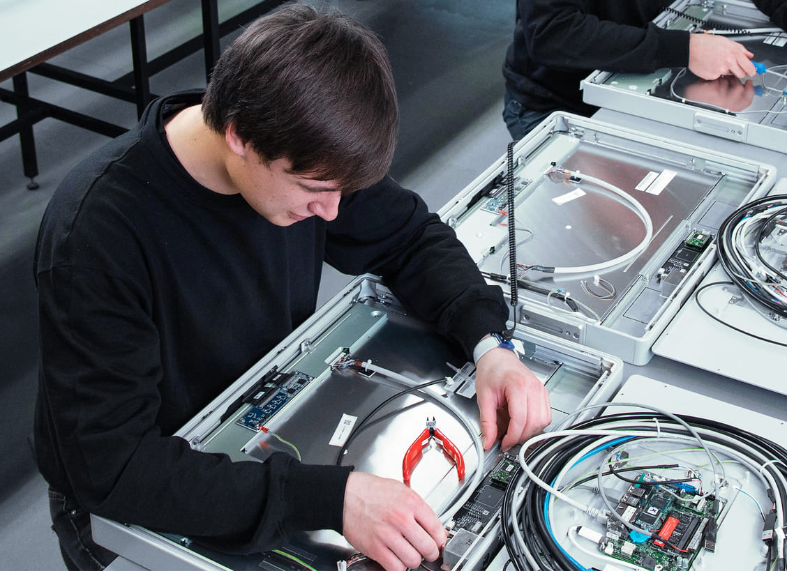 Technician assembling the inside of a panel PC housing