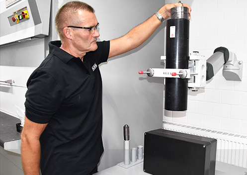 Technician running an impact test on a panel in a test lab