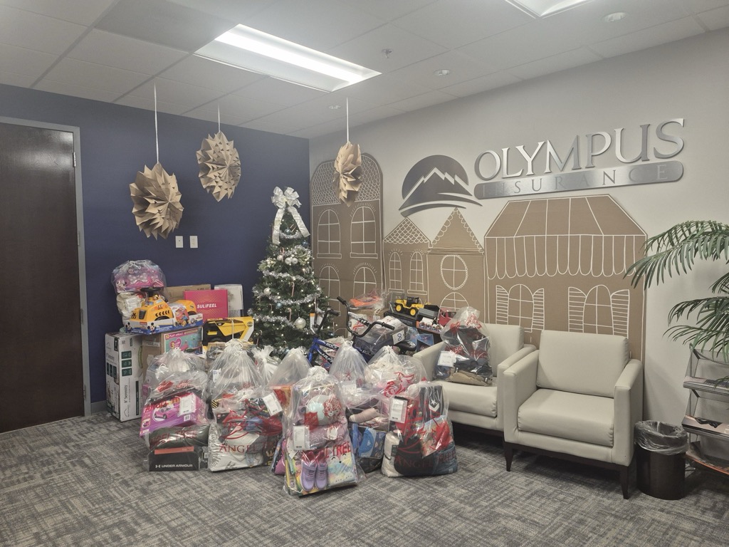 A room filled with lots of presents and a christmas tree.