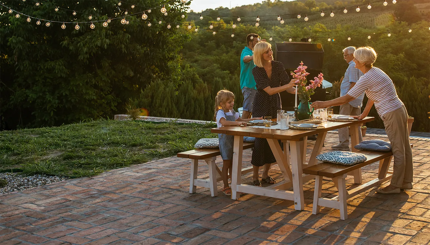 Family sharing an outdoor dinner on the patio of their Florida home