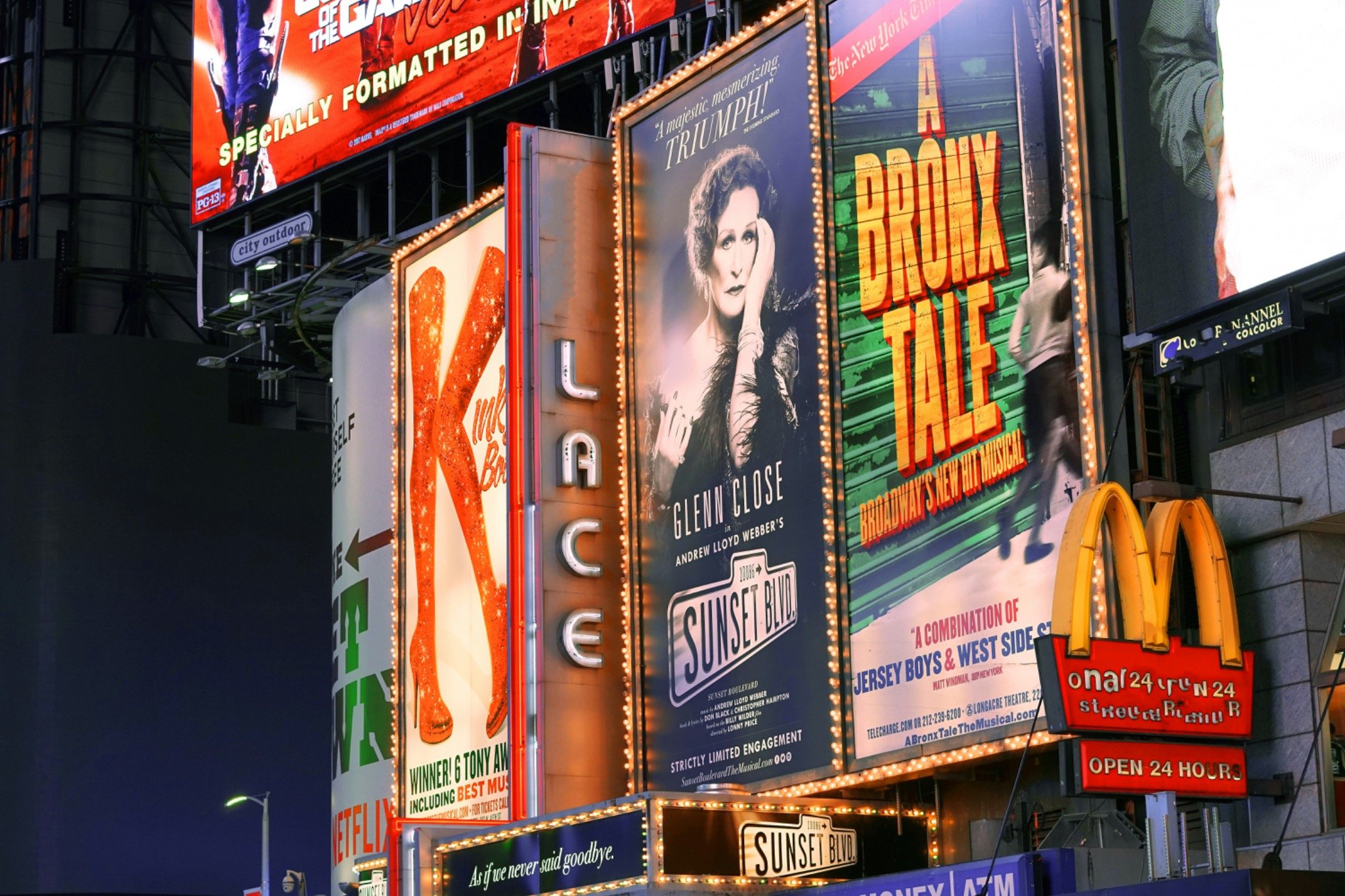 Bright Broadway billboards and neon signs at night.