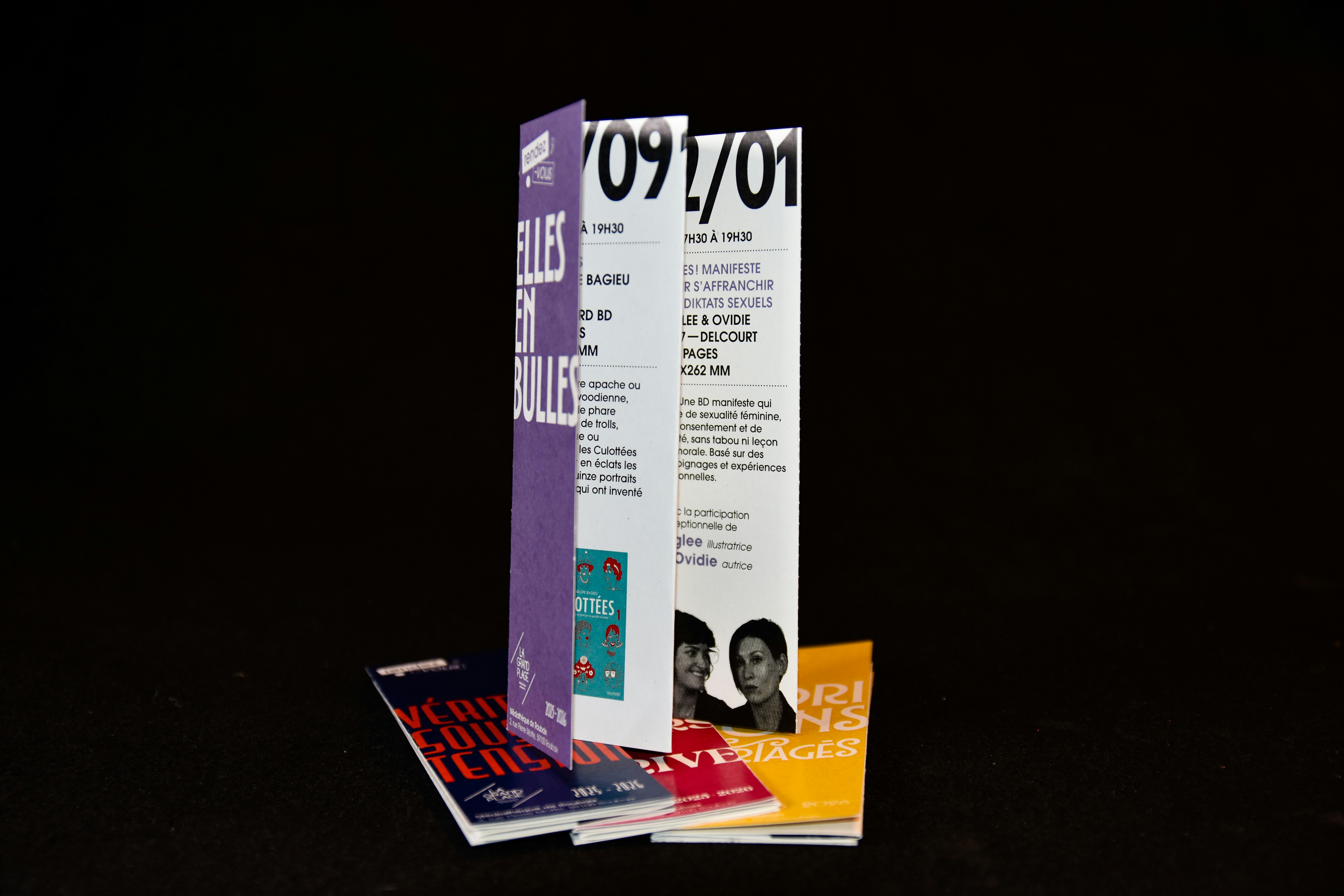 Minimalist brochure held in hand on dark background