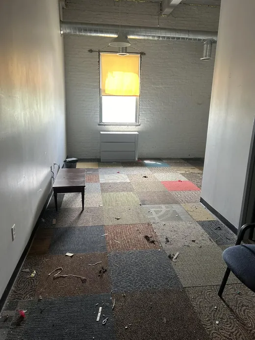 Before a deep cleaning in Miami: debris scattered on the office carpet