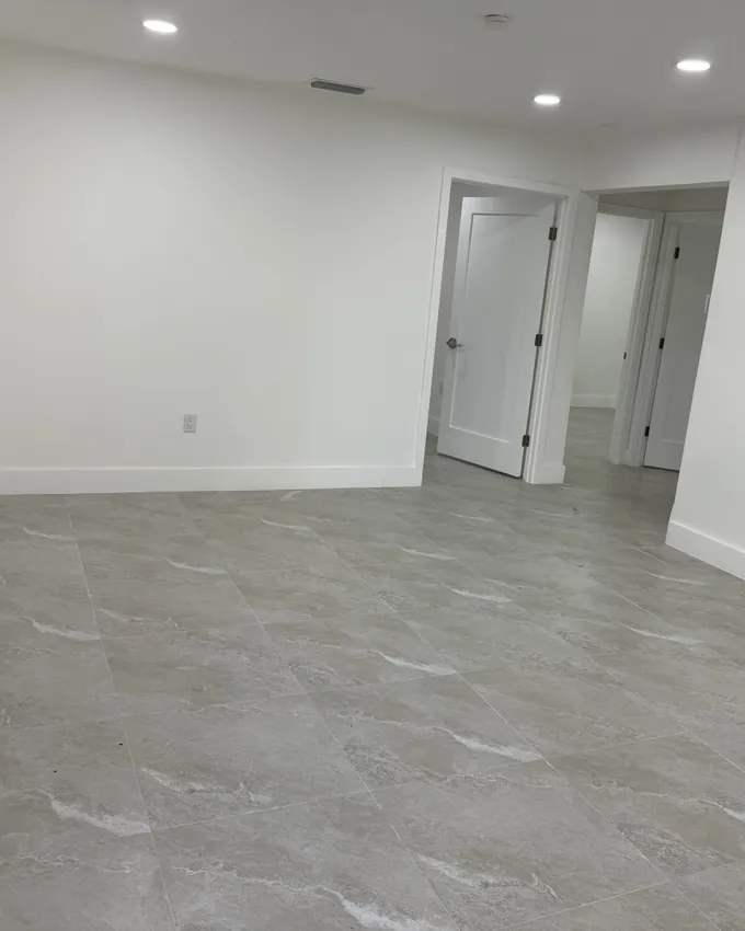 Renovated room with clean tile floors and baseboards after a post construction clean