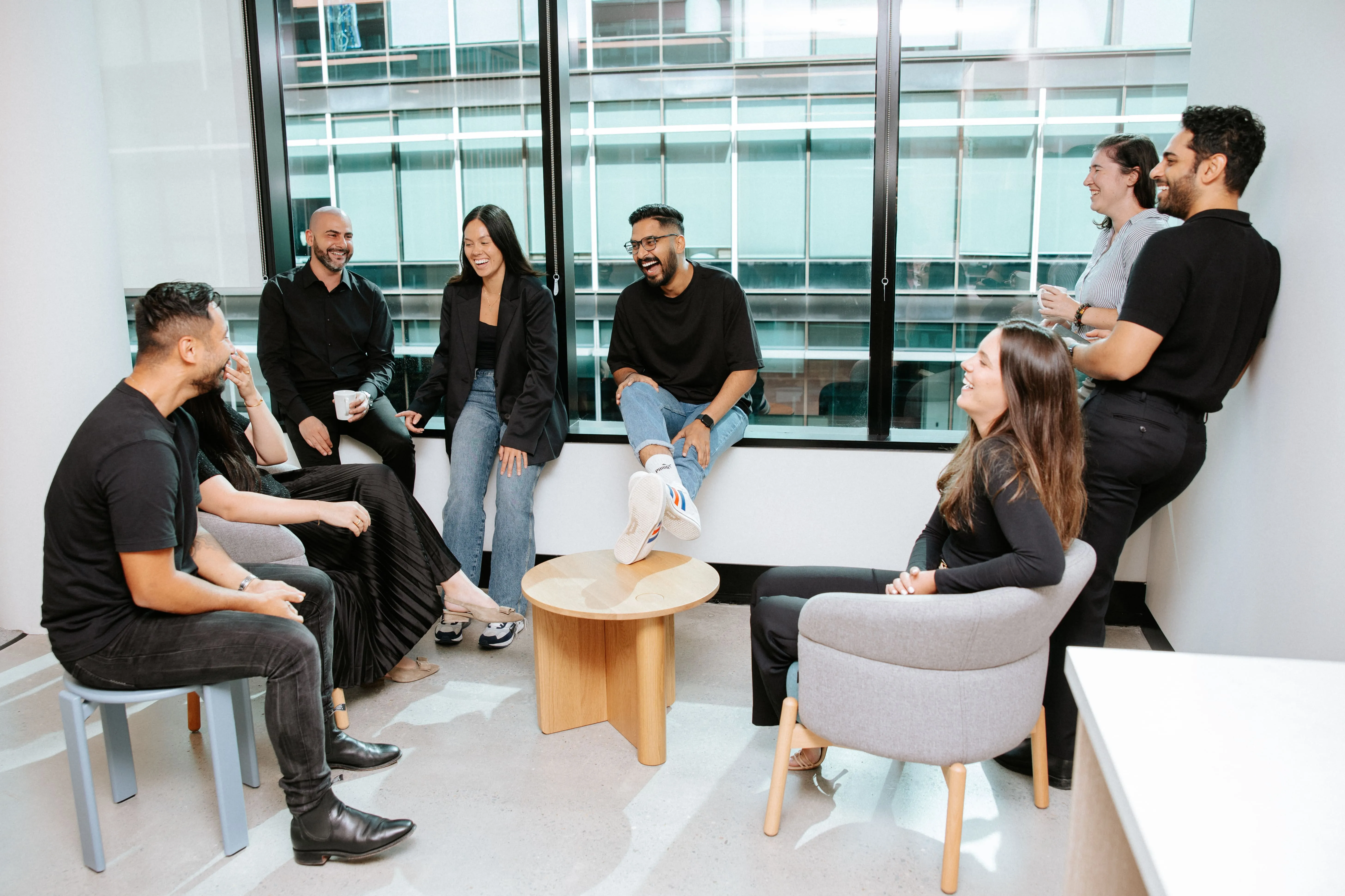 A group of people sitting around a table in a room.