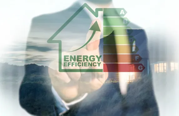 Businessman pointing at an energy efficiency rating chart with a rising arrow inside a house icon, symbolising sustainable property investment.