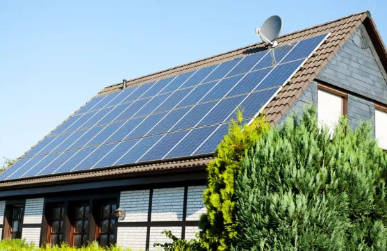 Modern house featuring a large rooftop solar panel array, representing energy-efficient home upgrades and renewable energy usage.