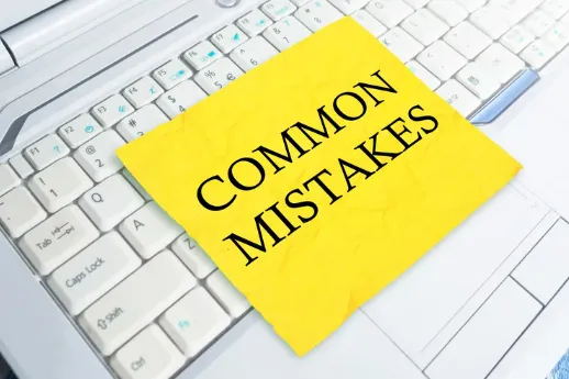 Yellow sticky note with the words "COMMON MISTAKES" placed on a laptop keyboard, highlighting financial or investment pitfalls to avoid.