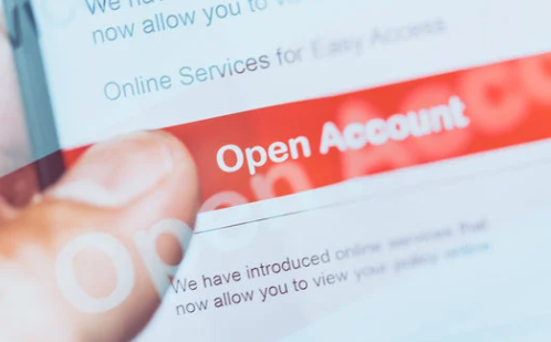 Hand tapping 'Open Account' on a digital banking app, representing the process of opening an online savings or checking account.