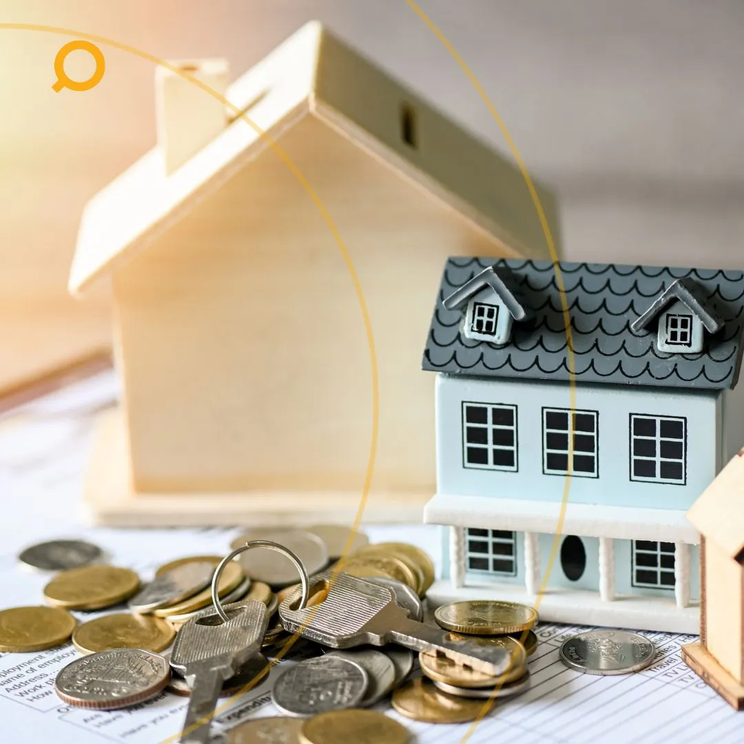 key and mini house on top of papers