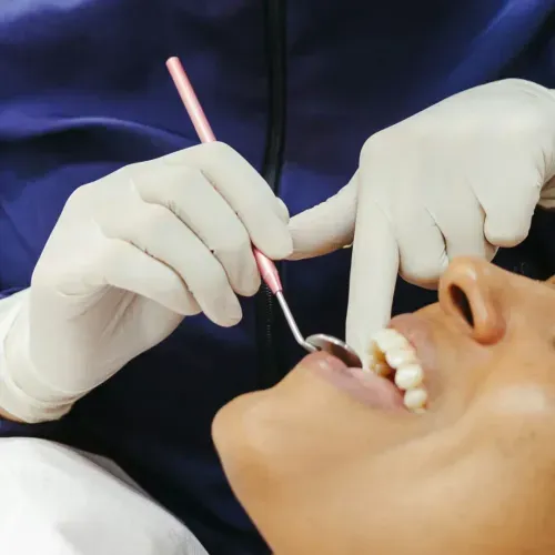a woman getting her teeth checked by a dentist