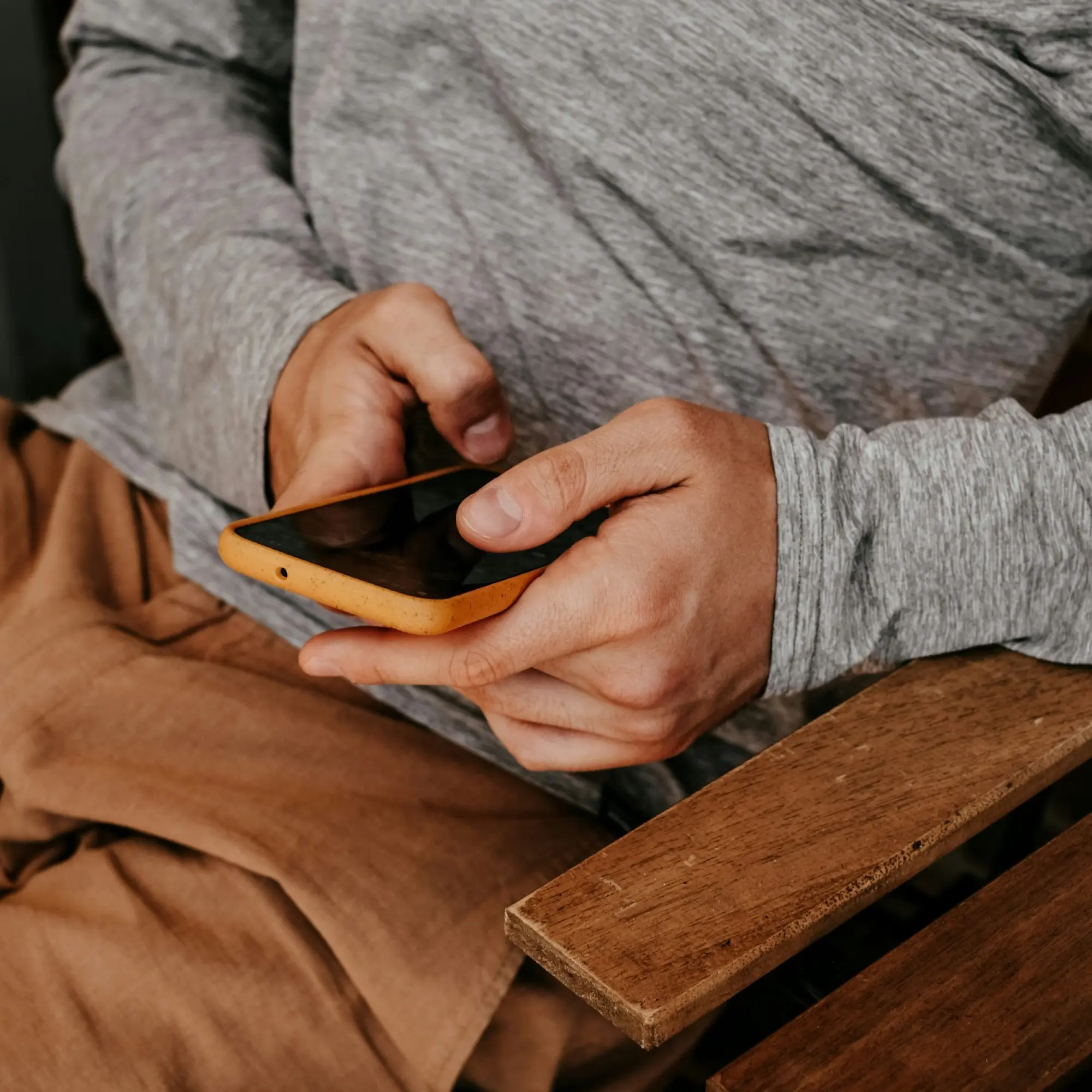 close-up on hands using a mobile device