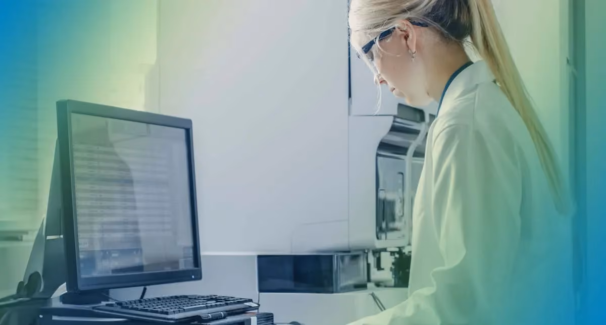 A physician stands at a computer working on careviso's seeQer platform to help patients access their healthcare.