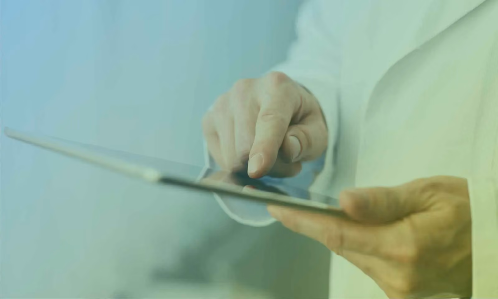 A physician about to push a button on a tablet. 