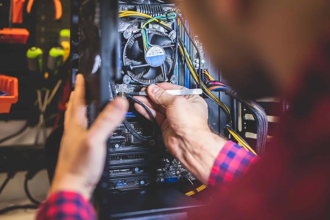 Technician working inside a desktop PC