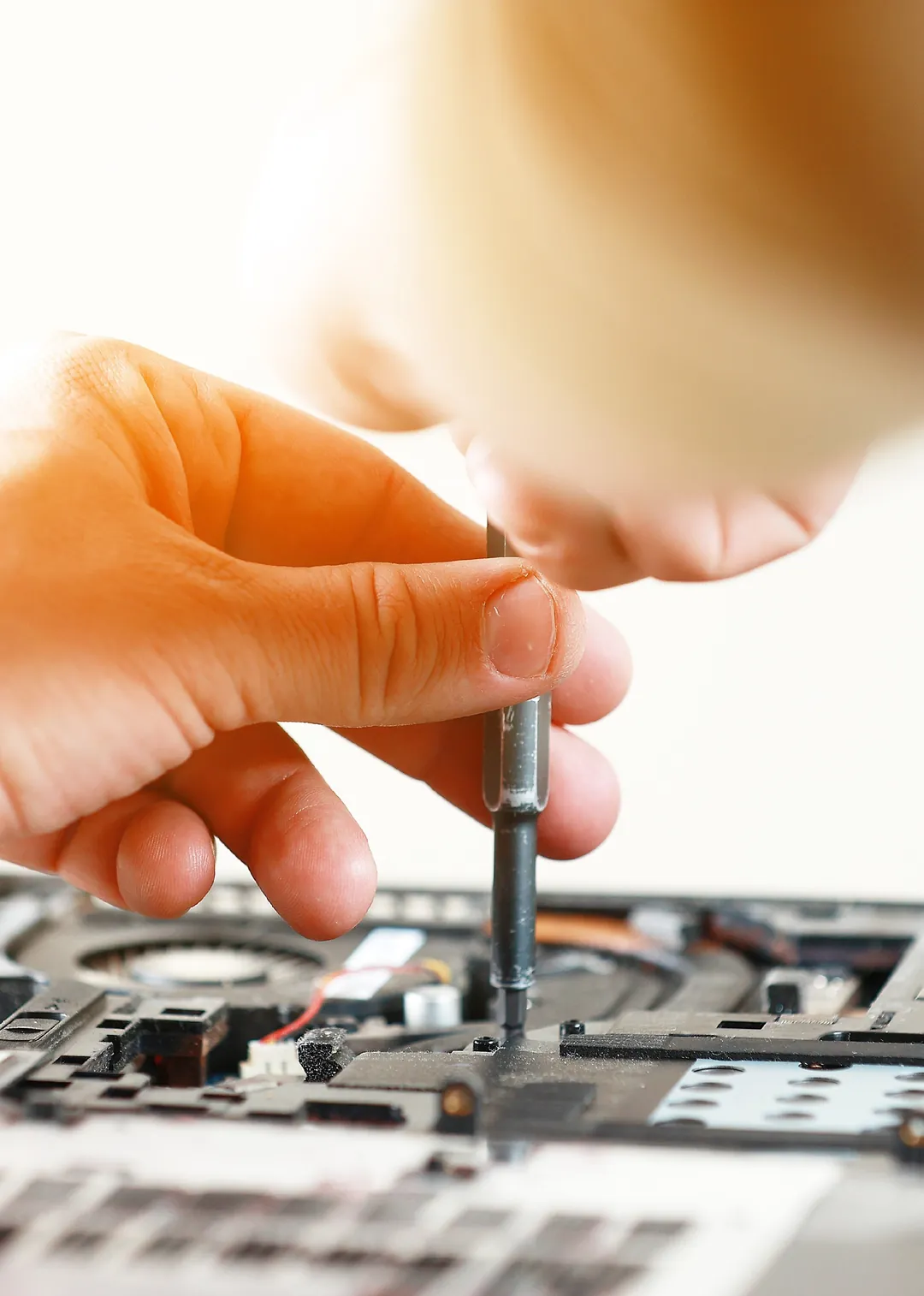 Repairing an electronic device with a precision screwdriver