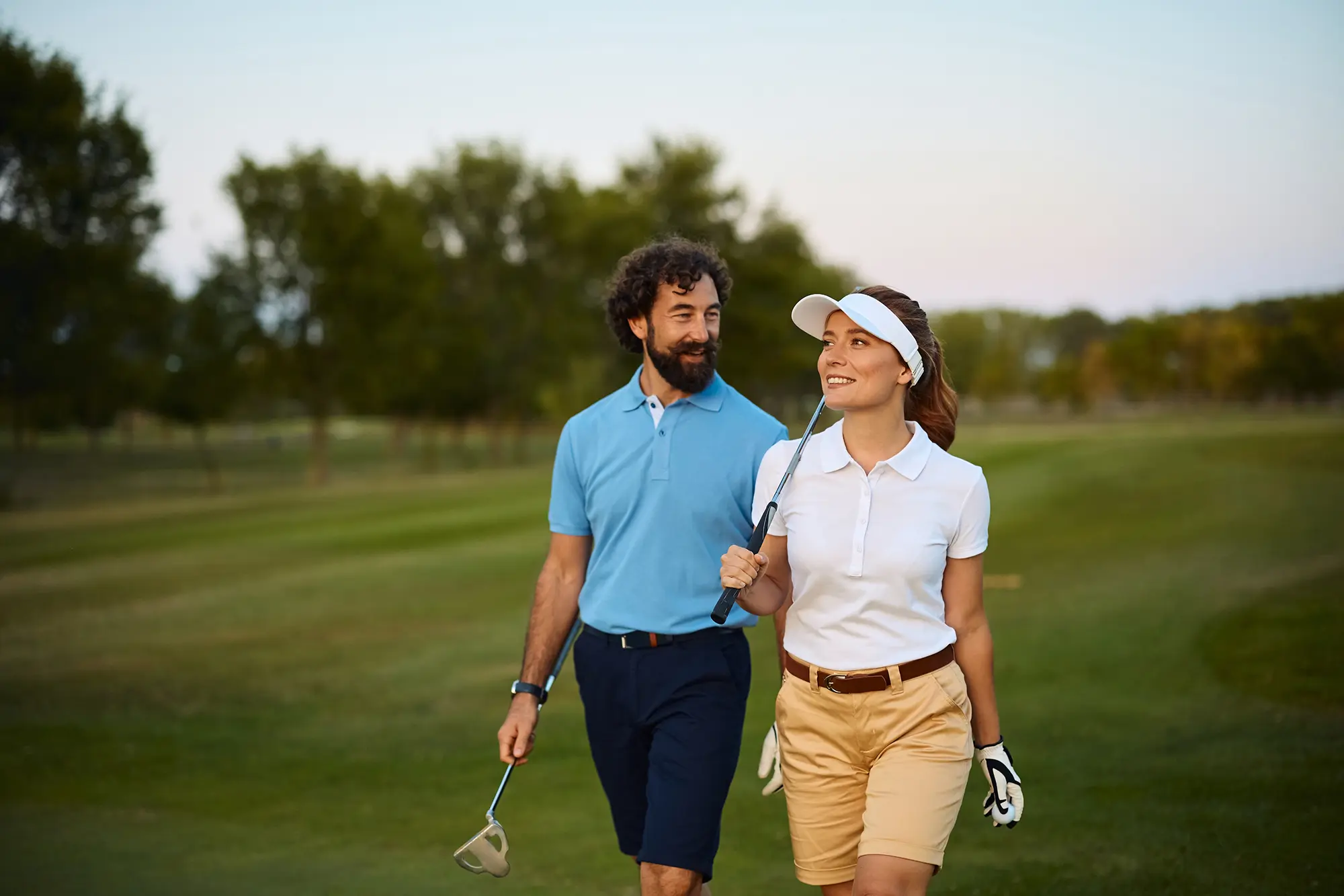 Two golf club members on the course, representing the member relationships supported by digital onboarding and verification.