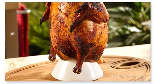 a whole chicken sitting on top of a wooden cutting board