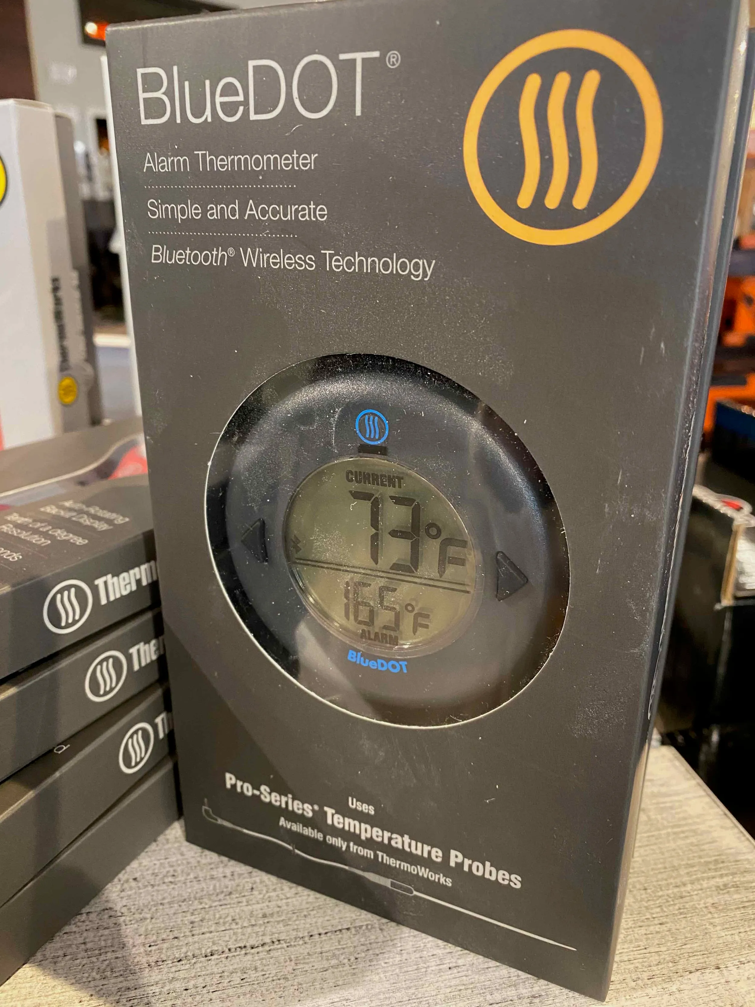 a blue dot alarm clock sitting on top of a table