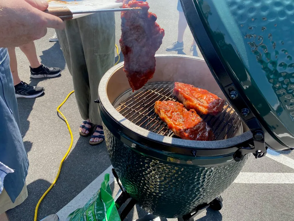 a person is cooking food on a grill