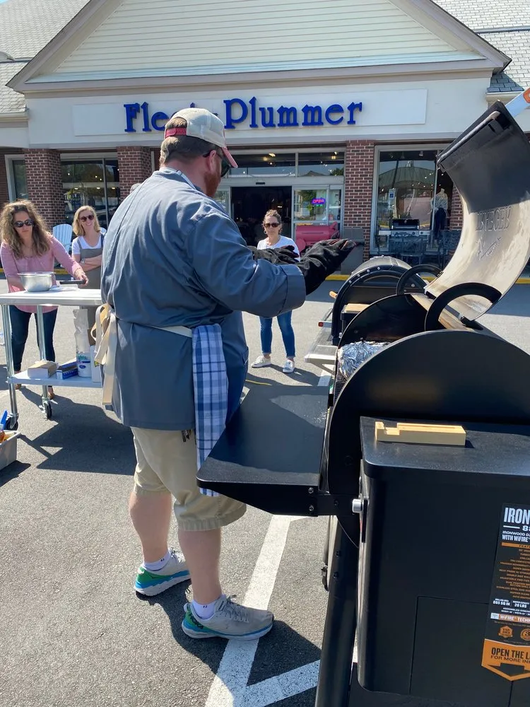 a man standing next to a mailbox in front of a store