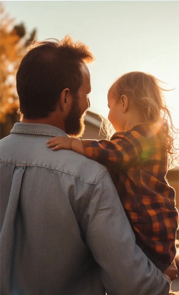 A man holding a little girl in his arms.