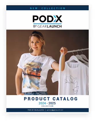 Woman wearing a white graphic t-shirt holding a hanger with another white t-shirt, on the cover of PODX by GearLaunch product catalog for 2024-2025.