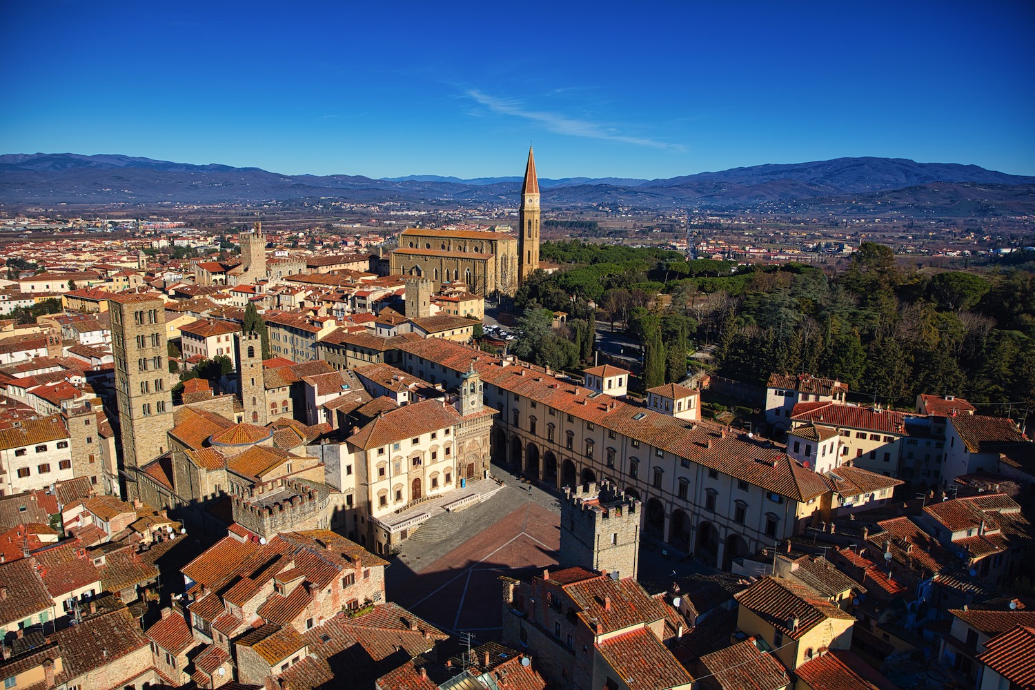 Medieval streets in Arezzo historic center, Tuscany, with stone buildings and warm evening light near Hotel Continentale.