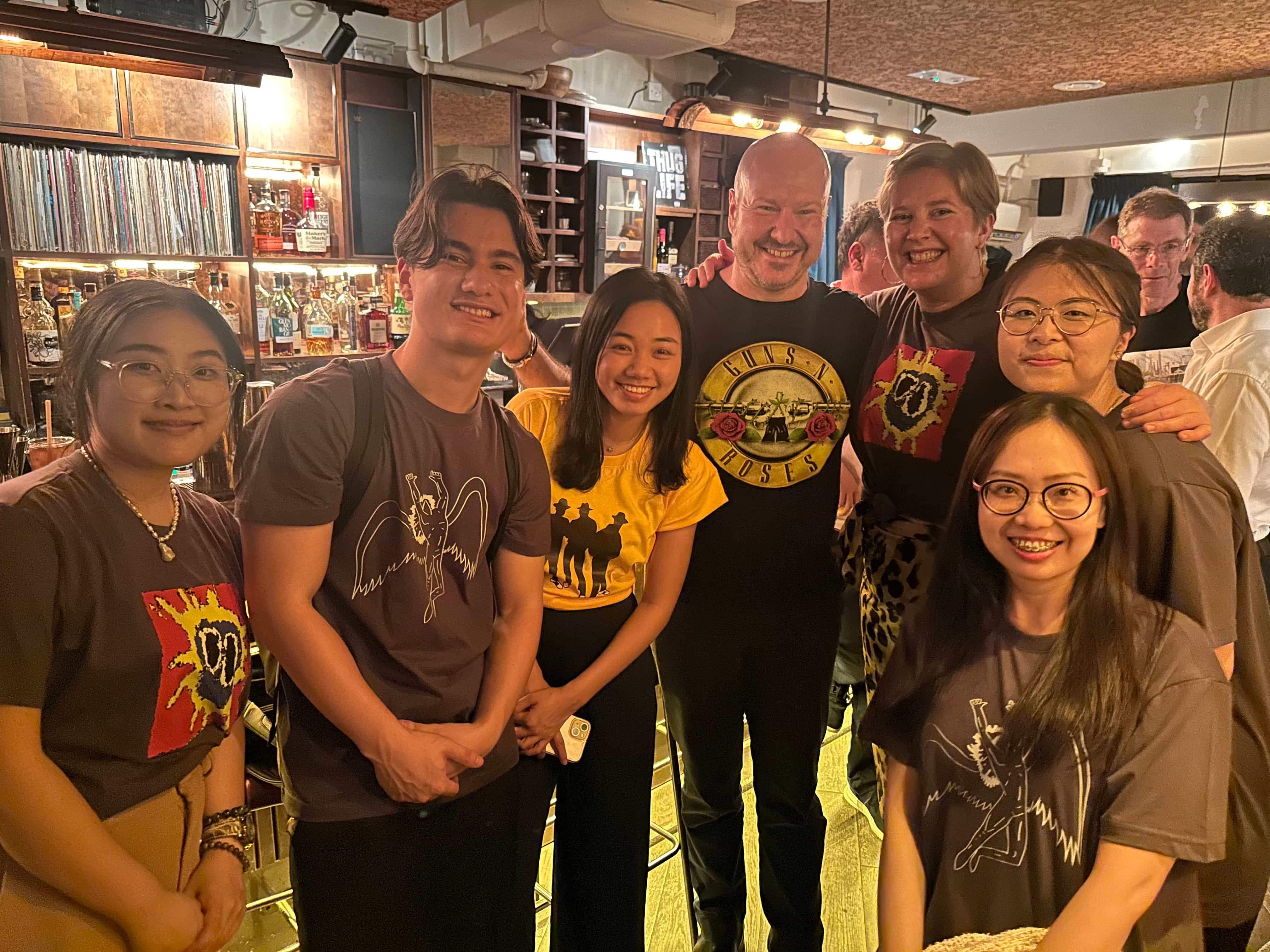 Beth Hackney, Margot Macinnis, Karen Petch, Sugano Yuri and Kotaro Fuji eating daan tat in Hong Kong bakery