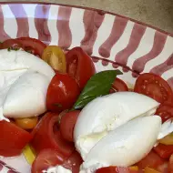 Melting ice cream cone held in front of a green door in Rome