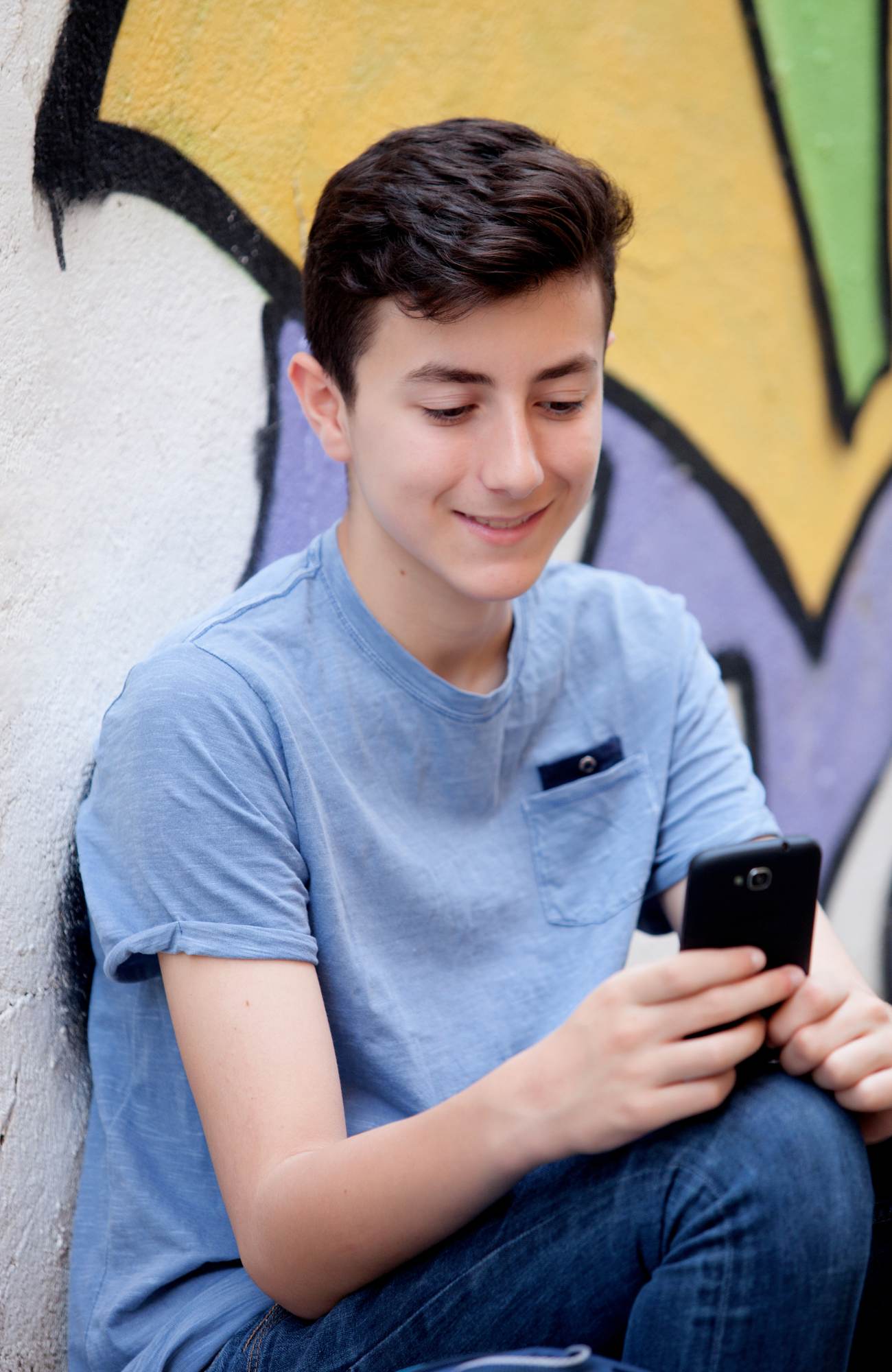 Person smiling holding a smartphone
