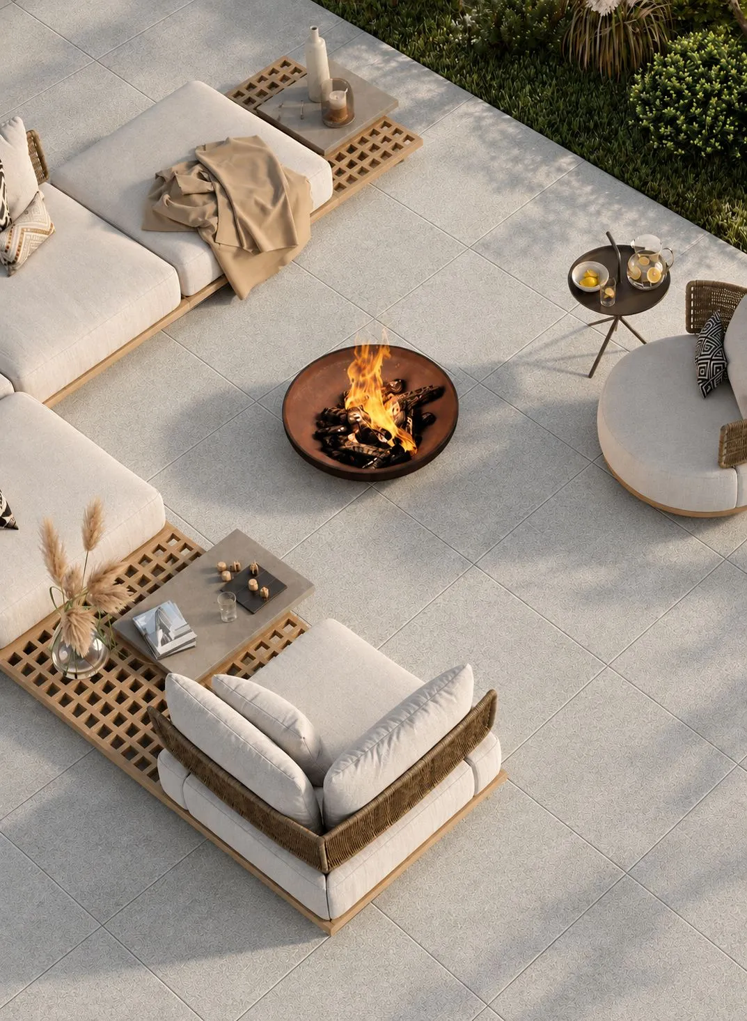 Tuscany Beige pavers surrounding a fire pit and lounge seating on an outdoor patio.