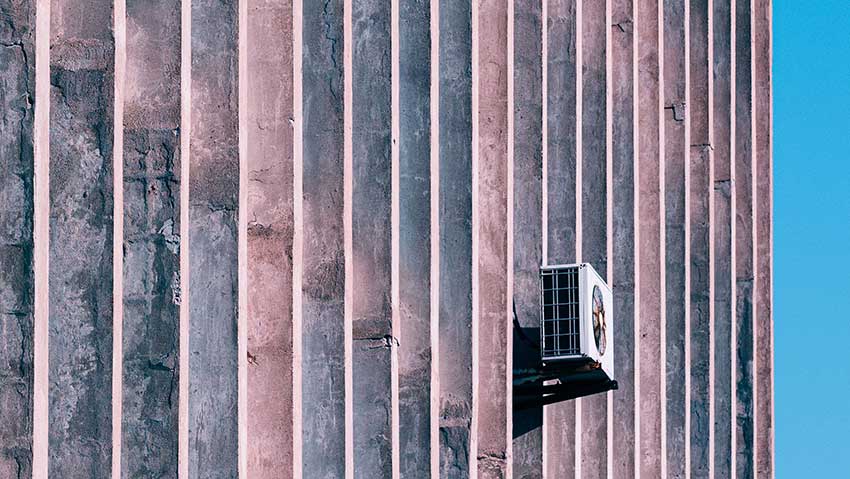 Outdoor HVAC unit illustrating seasonal building climate control and year-round system performance