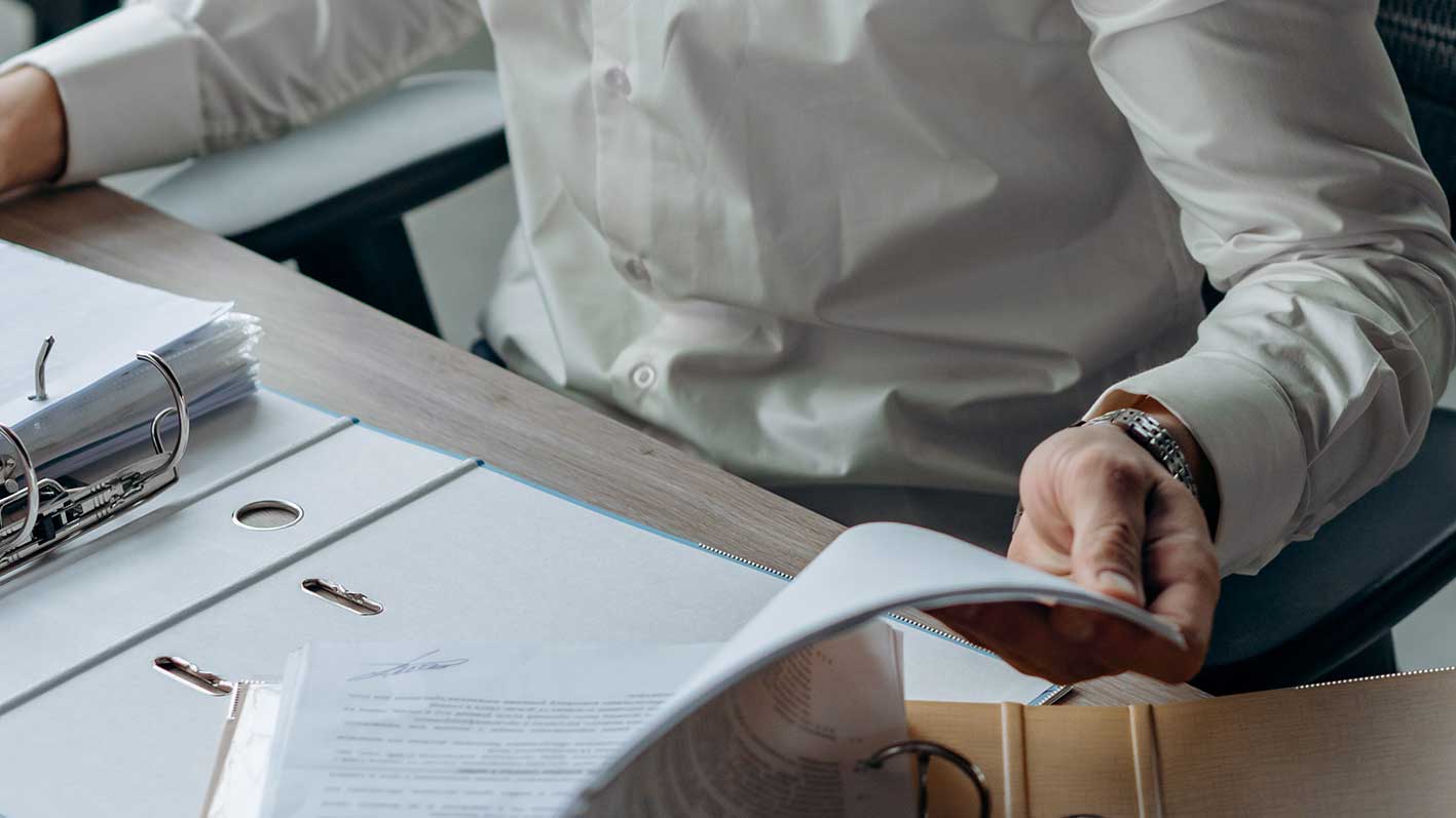 Engineer reviewing project documentation, representing the coordinated HVAC design workflows and engineering data management discussed in this article.