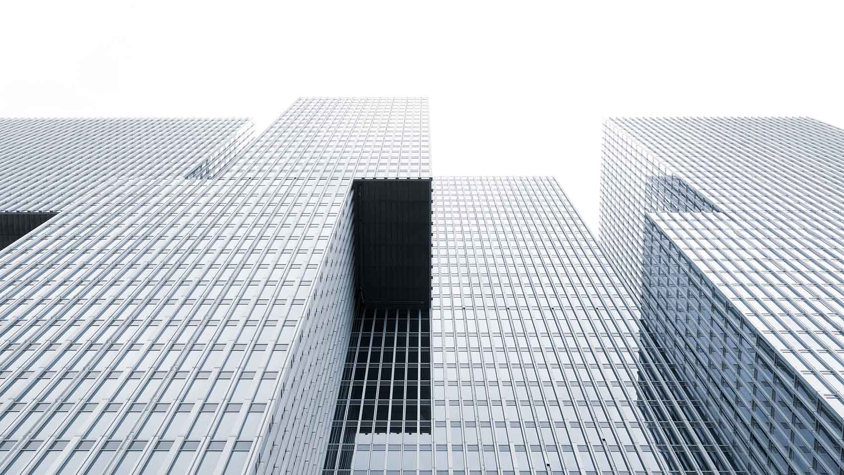 Modern commercial office buildings representing dynamic HVAC simulation, seasonal energy analysis and thermal comfort optimisation with Hysopt Simulator.