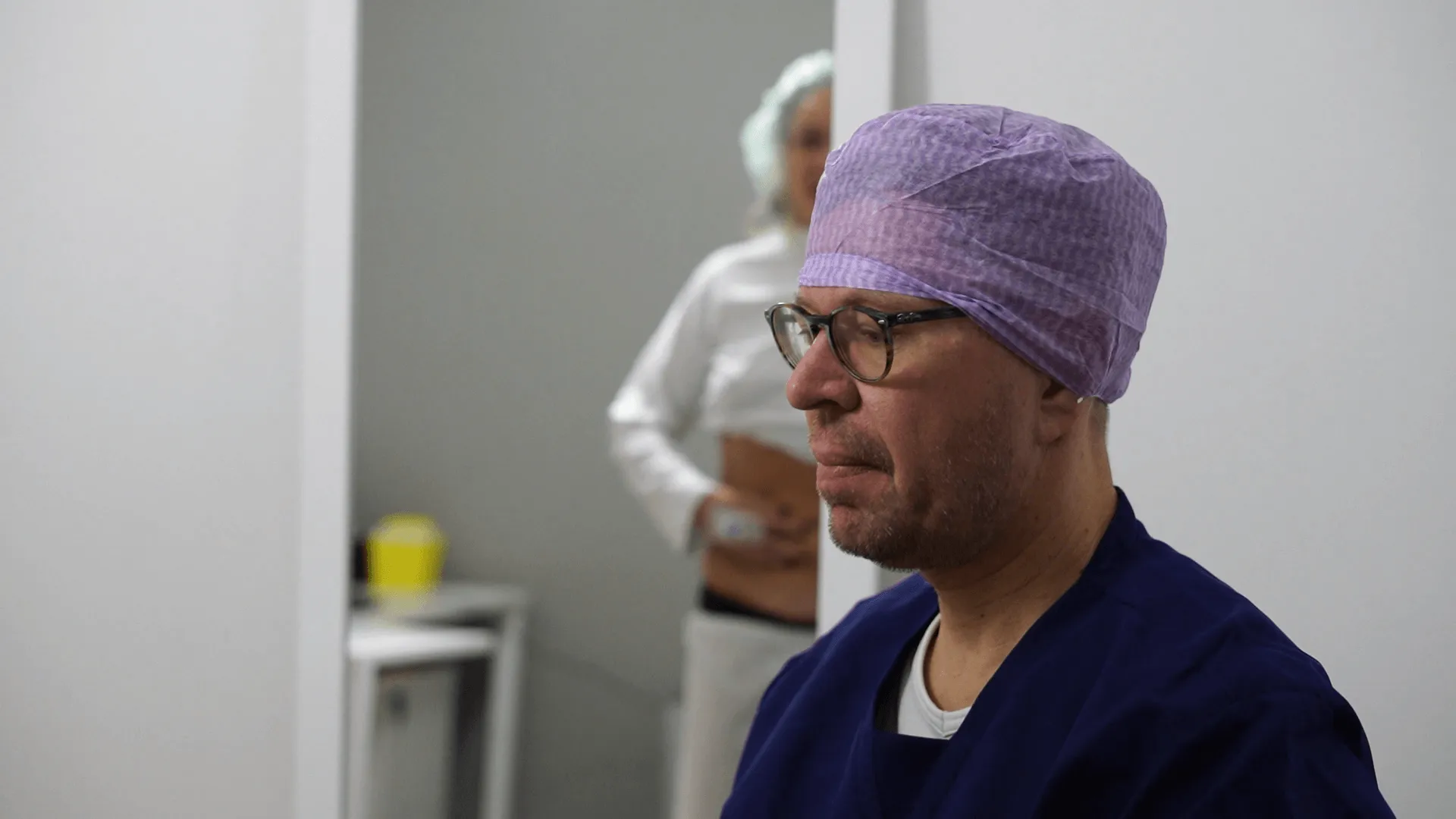 A man with a surgical bandage on his head.