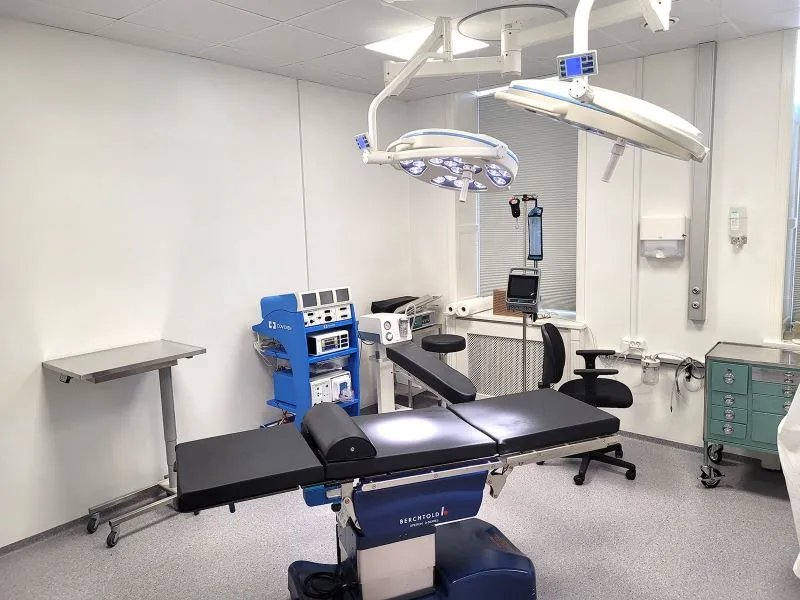 A hospital room with medical equipment and a bed.
