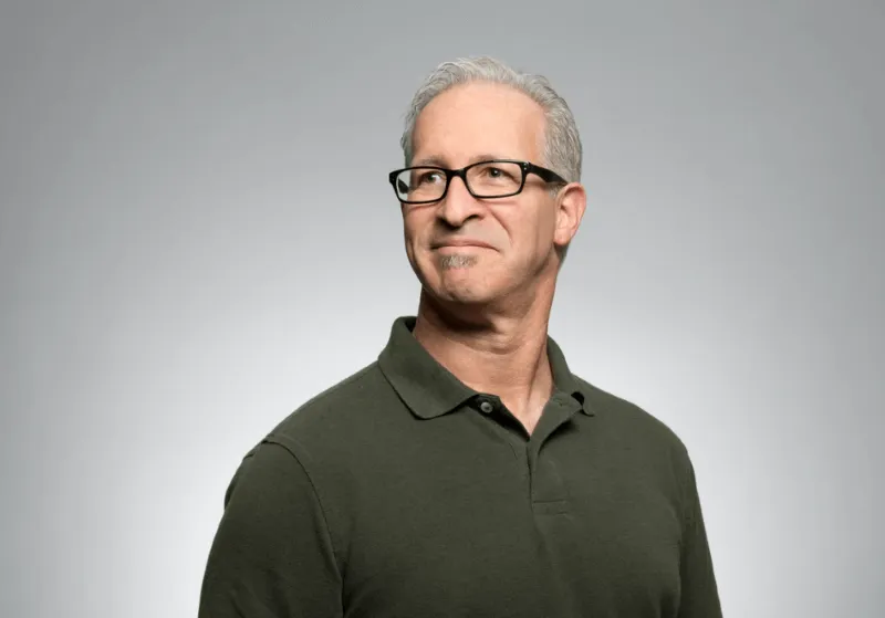 A man with glasses is posing for a picture.