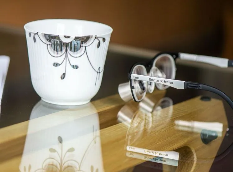 A pair of glasses sitting on top of a table.