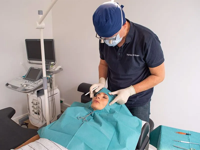 A woman in a face surgery