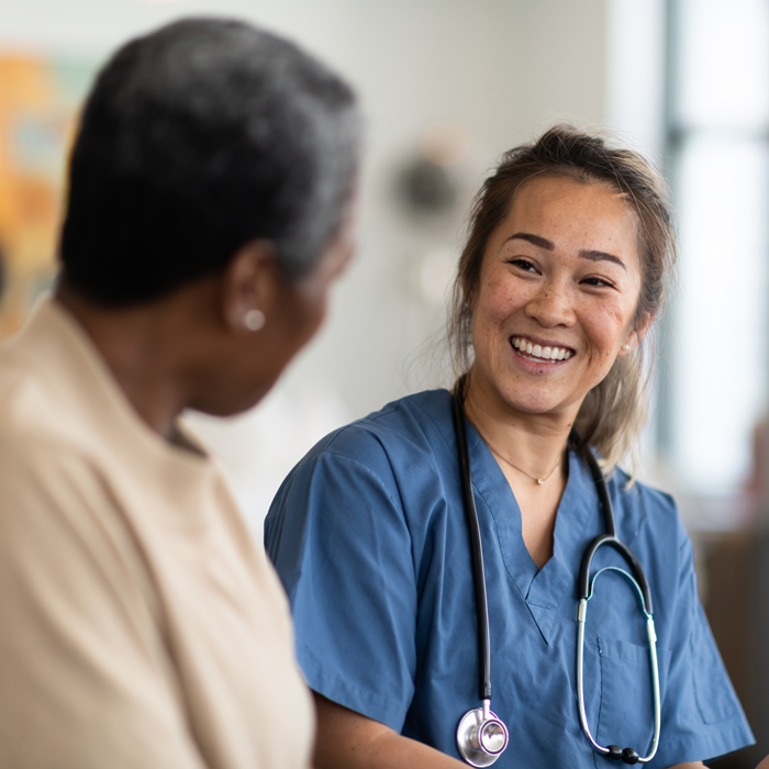 Nurse and patient talking to each other positively
