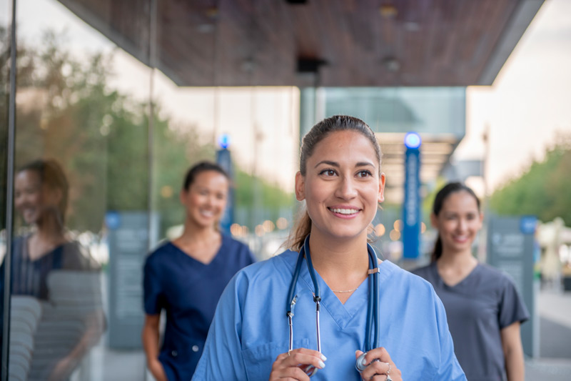 Three nurses staring confidently ahead