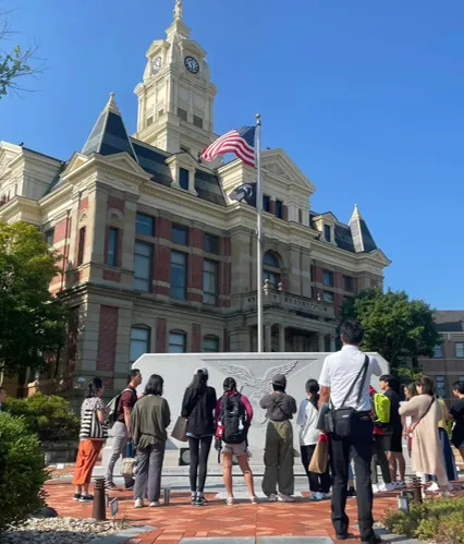 A group of people standing in front of a building.
