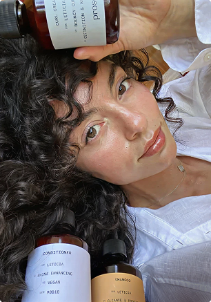 A woman with long hair and a white shirt.