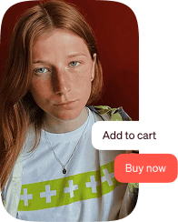 A woman with red hair wearing a white shirt with a cross on it.